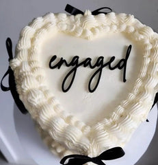 QPARTYFIRE engaged cake topper in black acrylic adds a sleek centerpiece.
