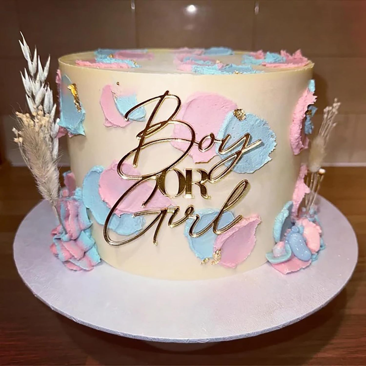 QPARTYFIRE gold acrylic boy or girl topper adds elegant gender reveal flair.