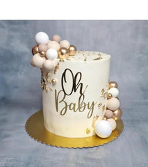 QPARTYFIRE Oh Baby gold acrylic cake topper enhancing a baby shower cake with elegance