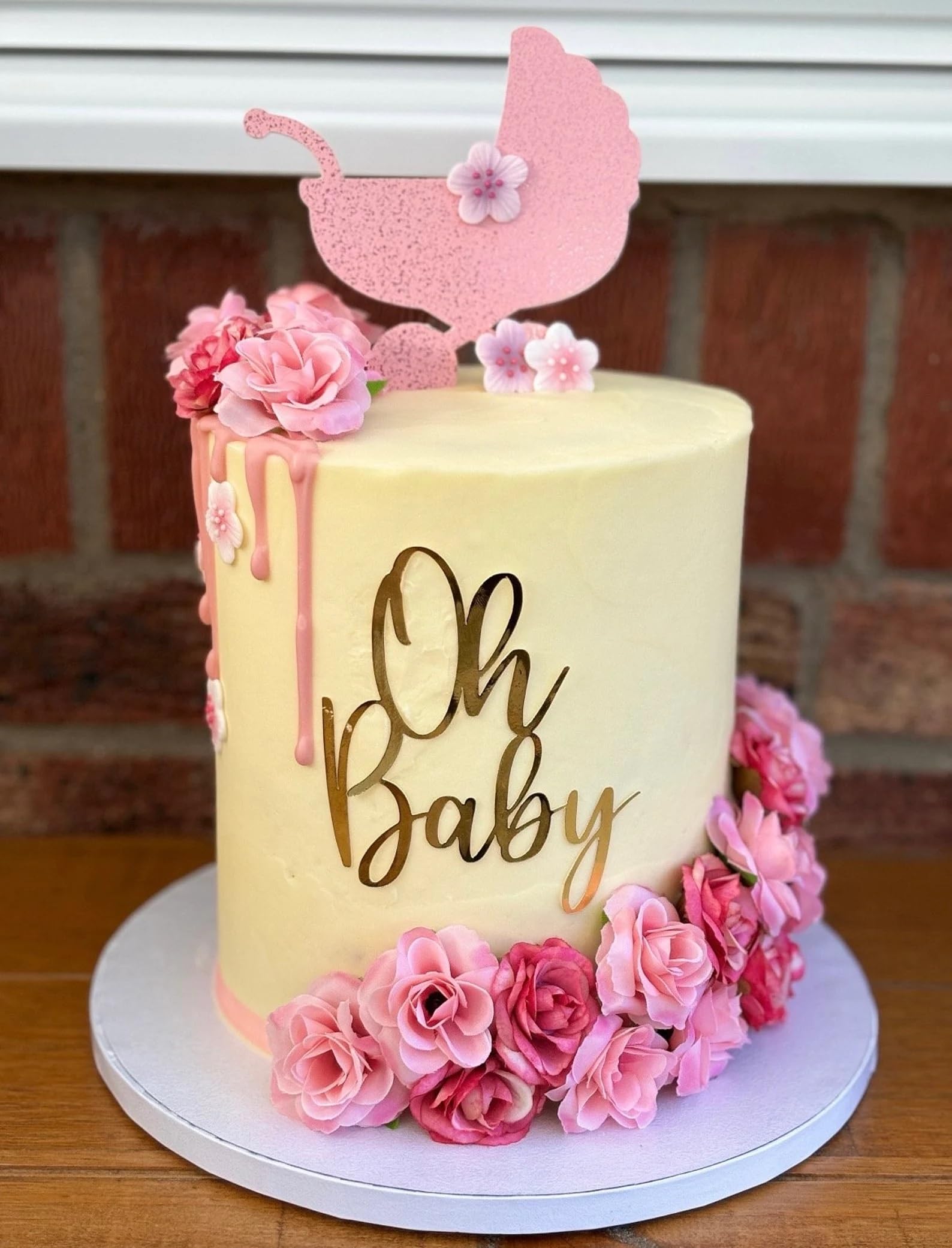 QPARTYFIRE Oh Baby topper in gold acrylic on a celebratory cake for gender reveal