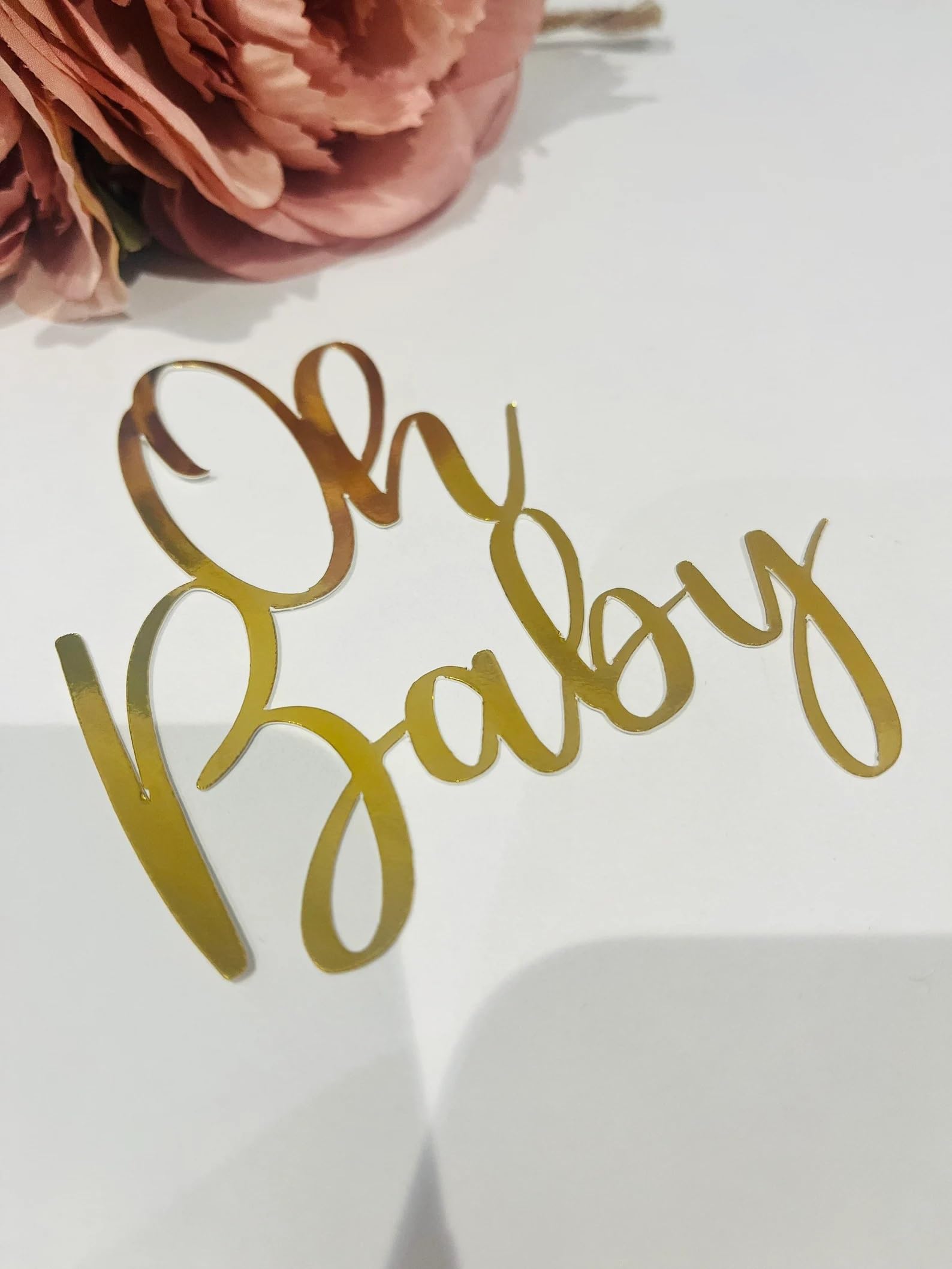 QPARTYFIRE Gold acrylic cake topper added to a cake in a photo-ready setup