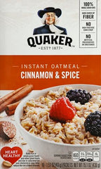 Quaker Instant Oatmeal Cinnamon Spice wooden spoon over ready porridge