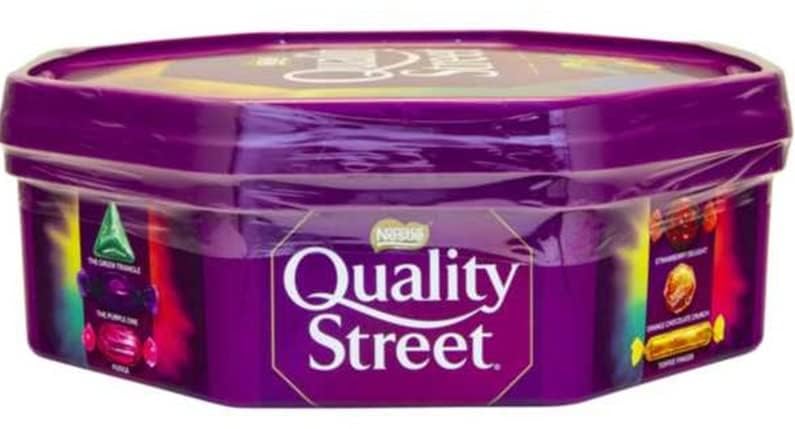Quality Street Chocolate Tub 550g on table, ready for Christmas or parties