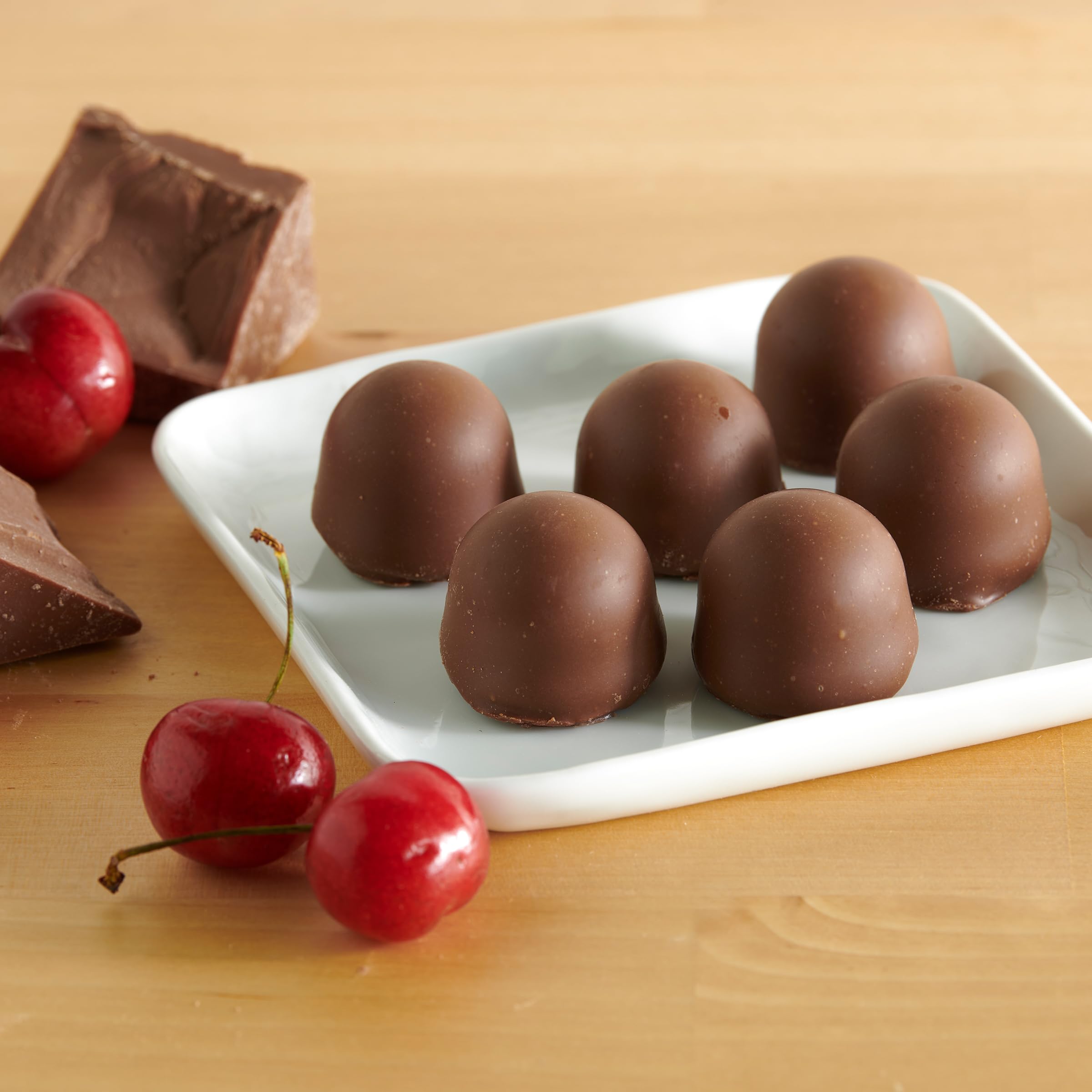Queen Anne chocolate cherries on a festive platter; ideal party dessert option.