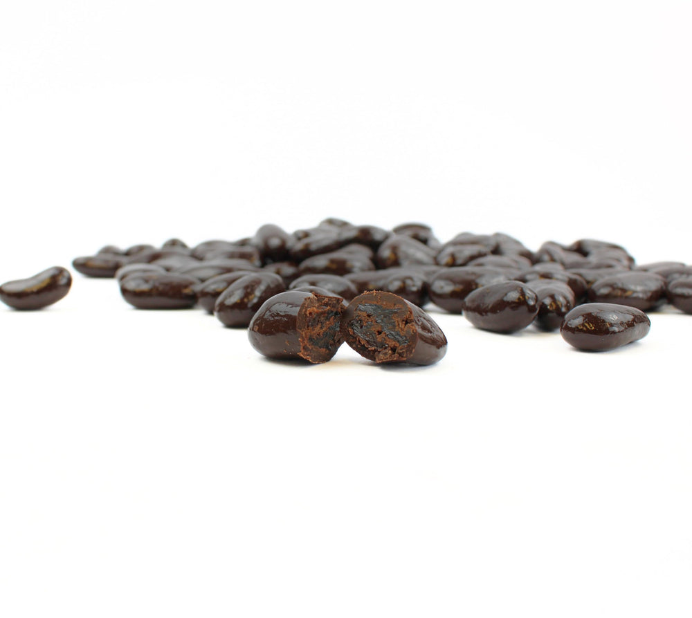 Queen City Candy Cave glossy dark chocolate coating highlights indulgent dessert-ready raisins