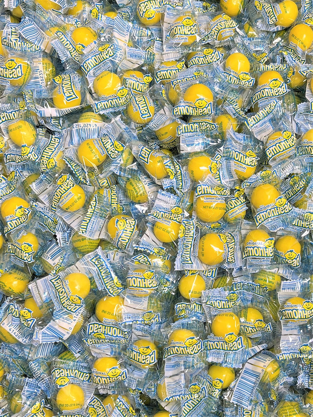 QUEEN JAX Lemonheads on a store shelf display for bulk purchase.