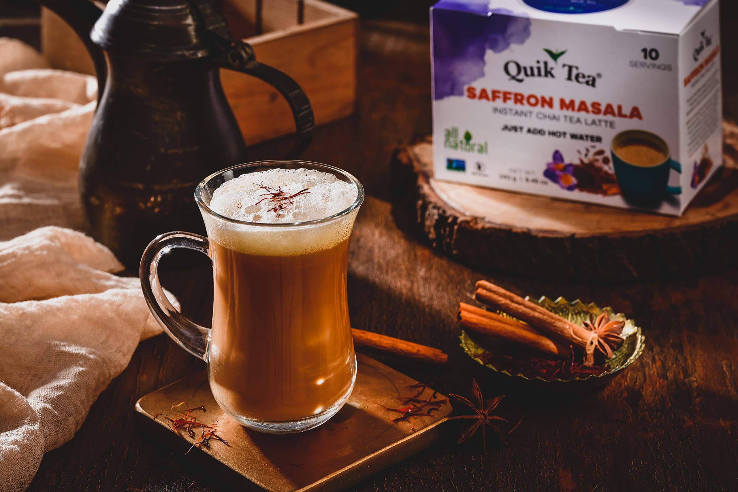 Quik Tea saffron masala chai latte steaming cup evokes cozy, inviting aroma