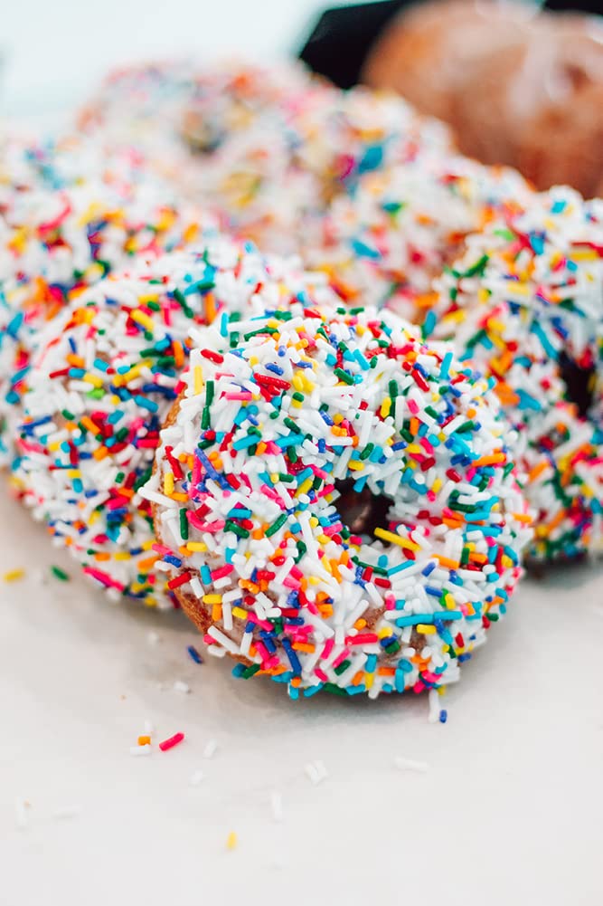 Rabbit Creek Confetti Donuts with rainbow sprinkles for festive treats.