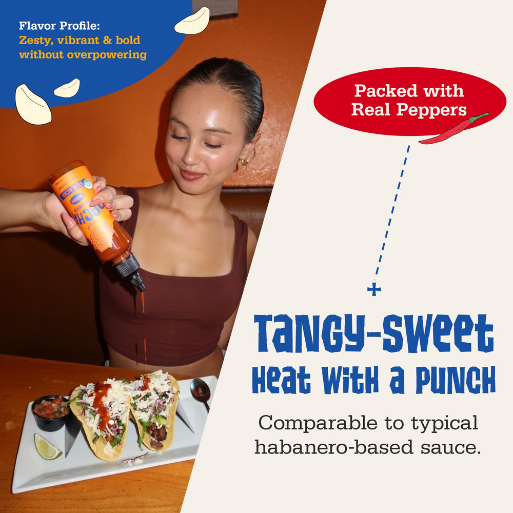 Racha Organics Orange Racha bottle pouring over wings to show balanced heat.