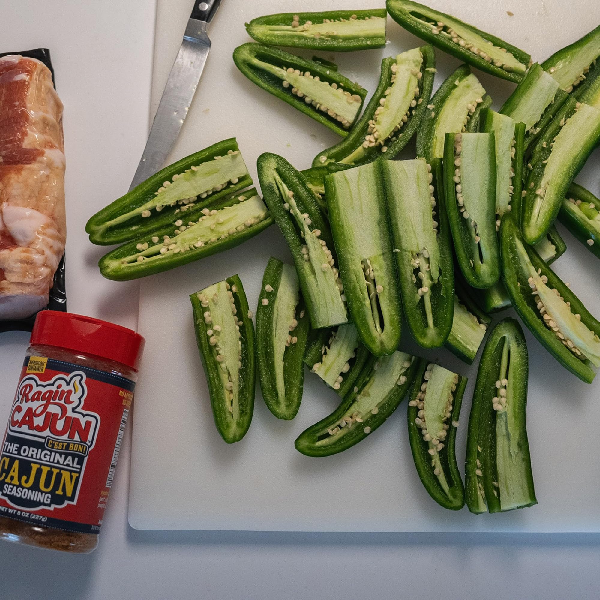 Ragin' Cajun Original Seasoning shaker on skillet, quick flavor boost
