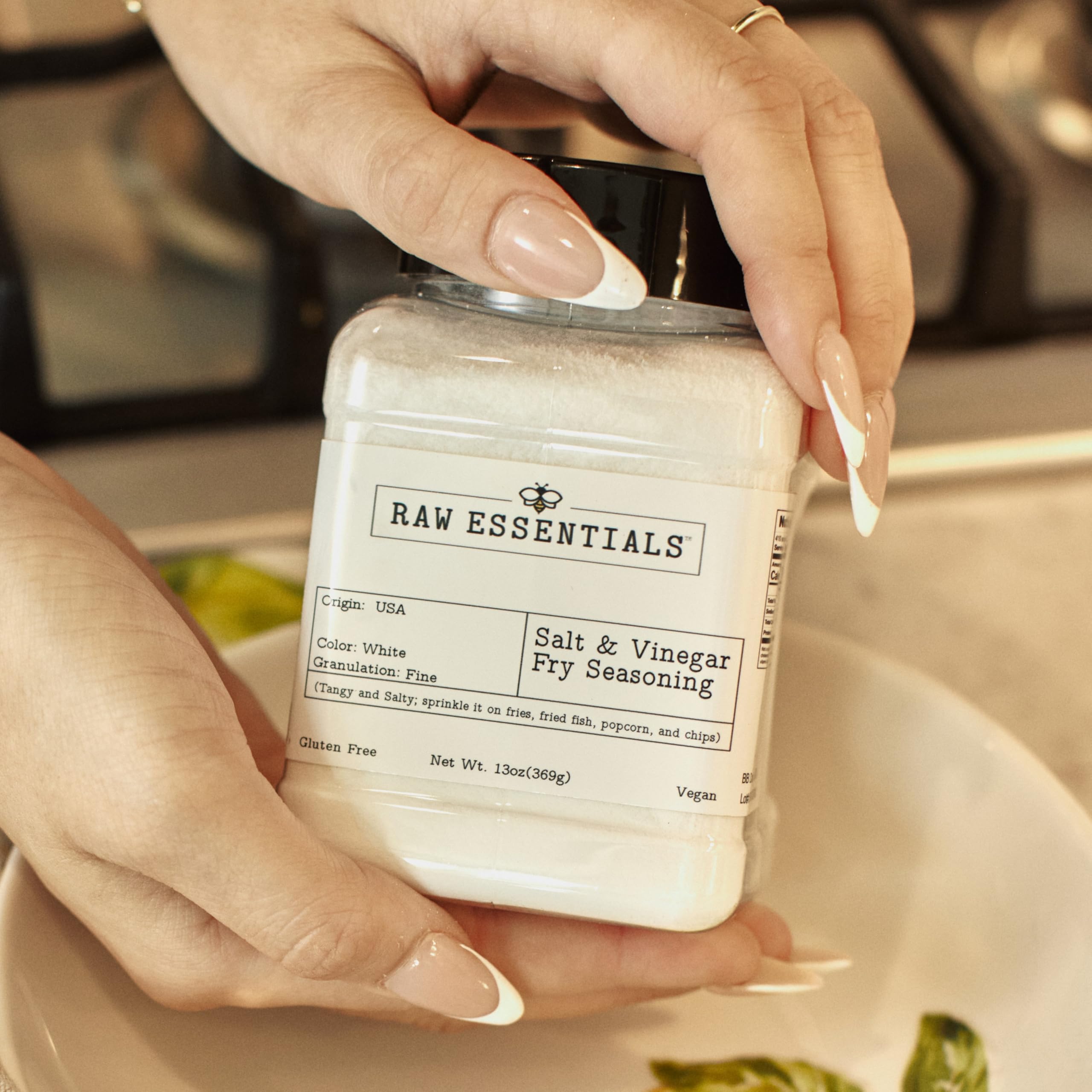 Raw Essentials Salt and Vinegar Fry Seasoning on a platter of golden fries