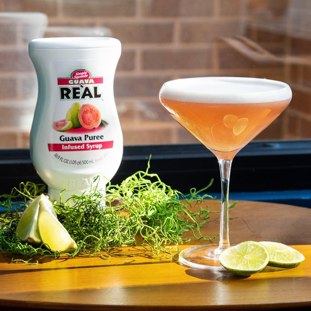 Reàl Infused Exotics Guava Syrup splash in glass inspires refreshing drinks