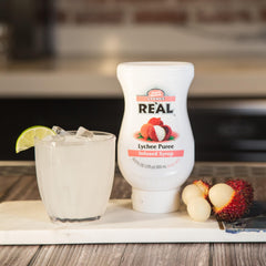 Reàl Infused Exotics Lychee bottle trio packaging highlights value.