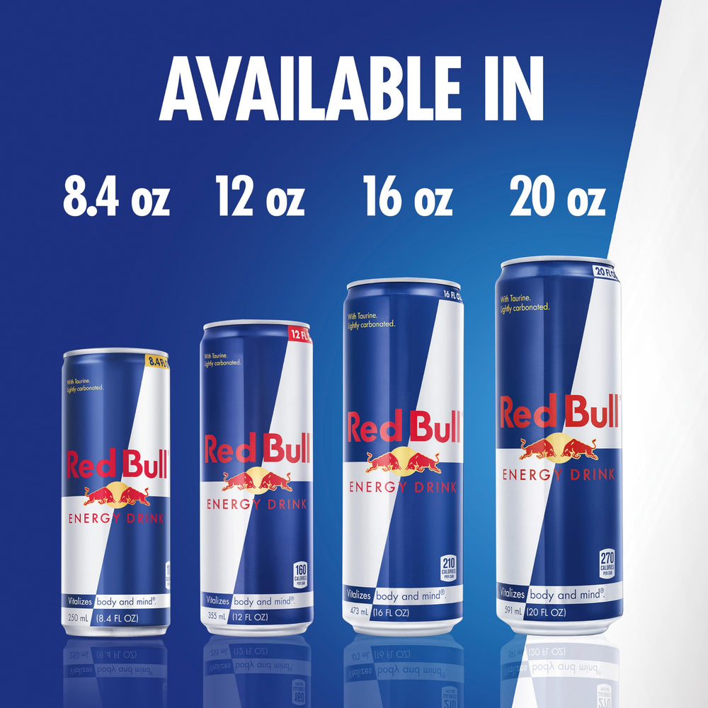Red Bull energy drink in gaming setup with keyboard and headset foreground.