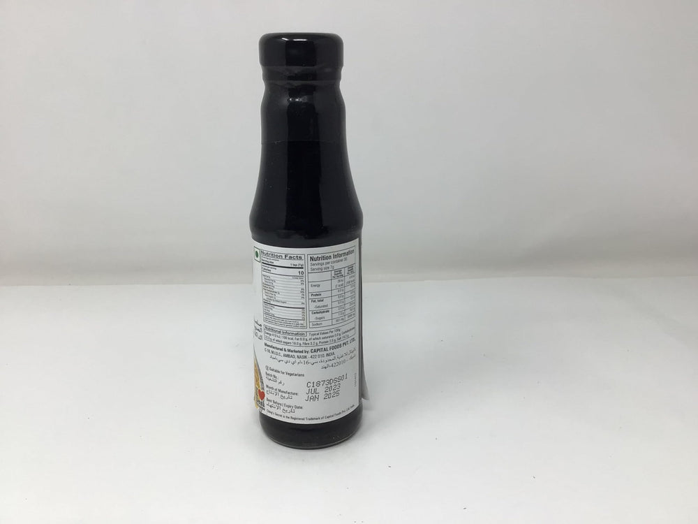 Glass bottle of Chings Dark Soy Sauce with a steady pour.