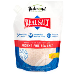 Redmond Real Sea Salt bottle pouring enhances flavor with a subtle sweet finish in cooking