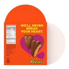 REESE'S heart-shaped candies close-up with creamy peanut butter center.