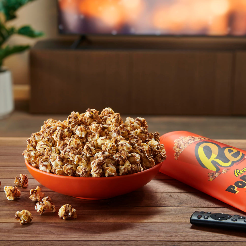 Desk-friendly Reese's Popcorn snack, perfect for travel and trips
