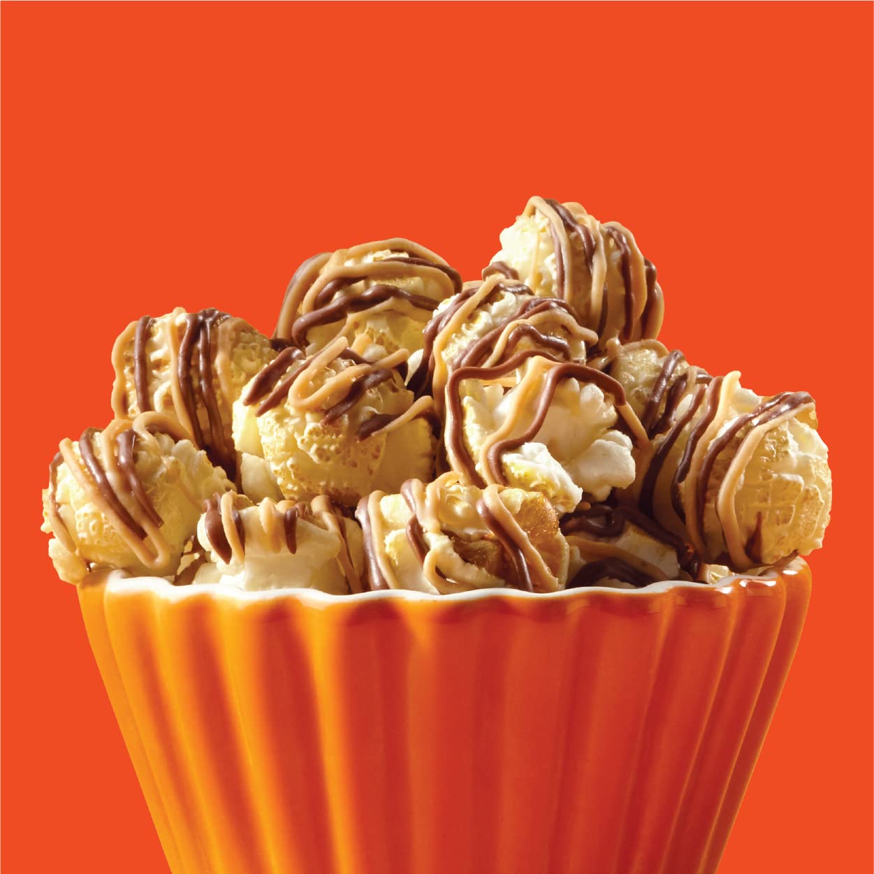 Sweet and salty Reese's Popcorn with chocolate drizzle on top