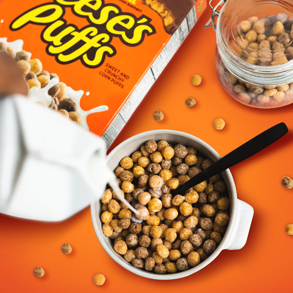 Reese's Puffs cereal crunch close-up showing golden puff texture.