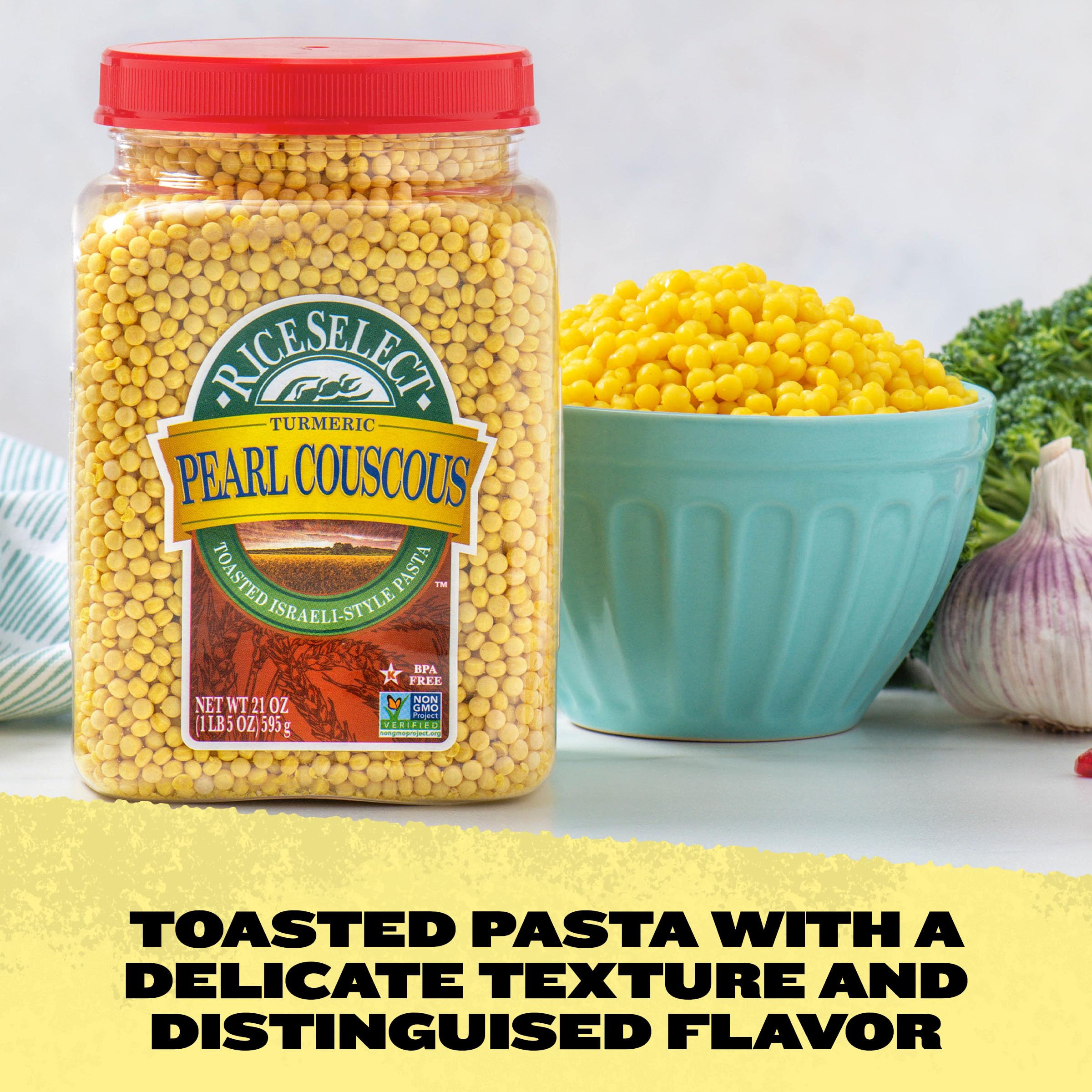 RiceSelect Pearl Couscous with Turmeric plated with vegetables and lemon vinaigrette for a Mediterranean-inspired dish.