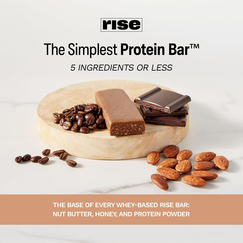 Rise Mocha Almond bar on a desk beside coffee for morning routine.
