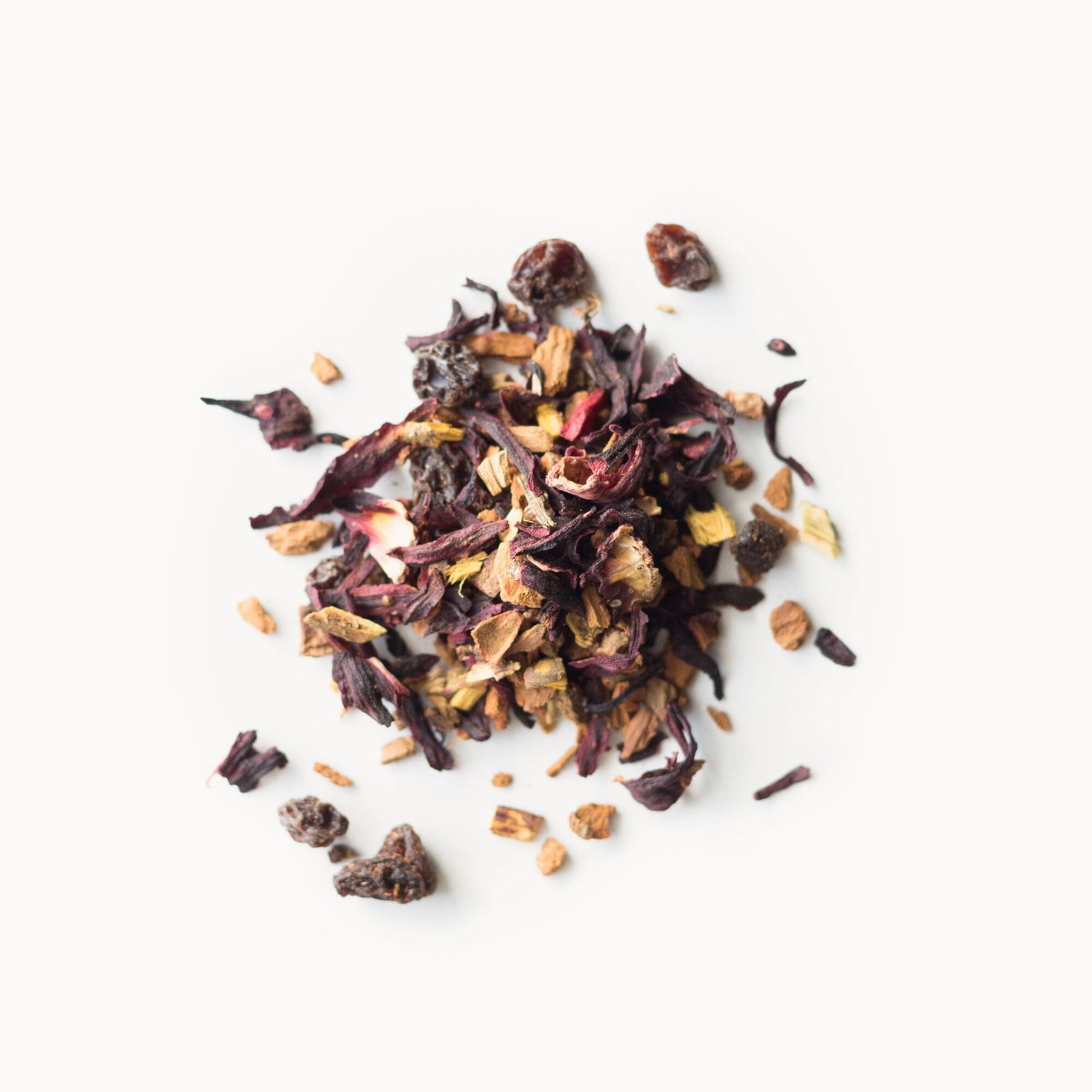 Rishi Cinnamon Plum tea being poured from a teapot into a cup.