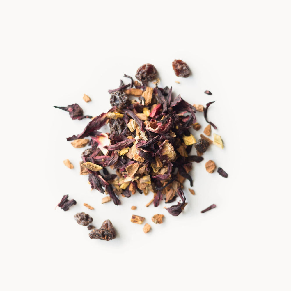 Rishi Cinnamon Plum tea being poured from a teapot into a cup.