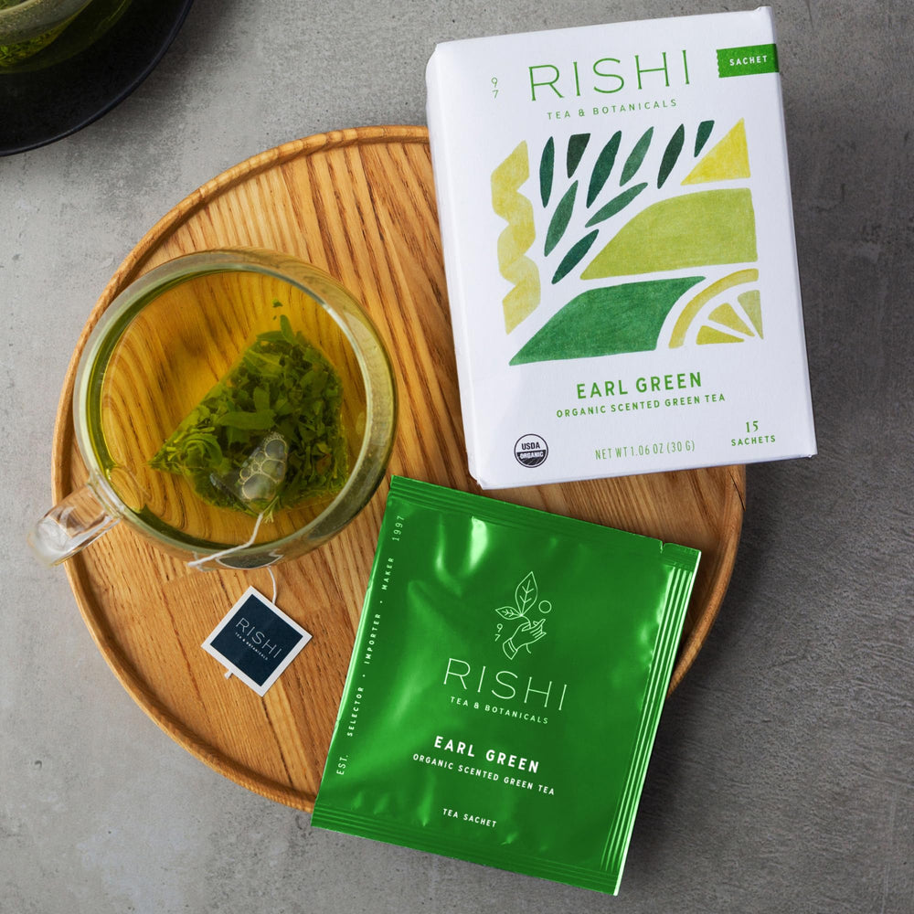 Brewed Earl Green tea in a cup with steam and bright aroma.