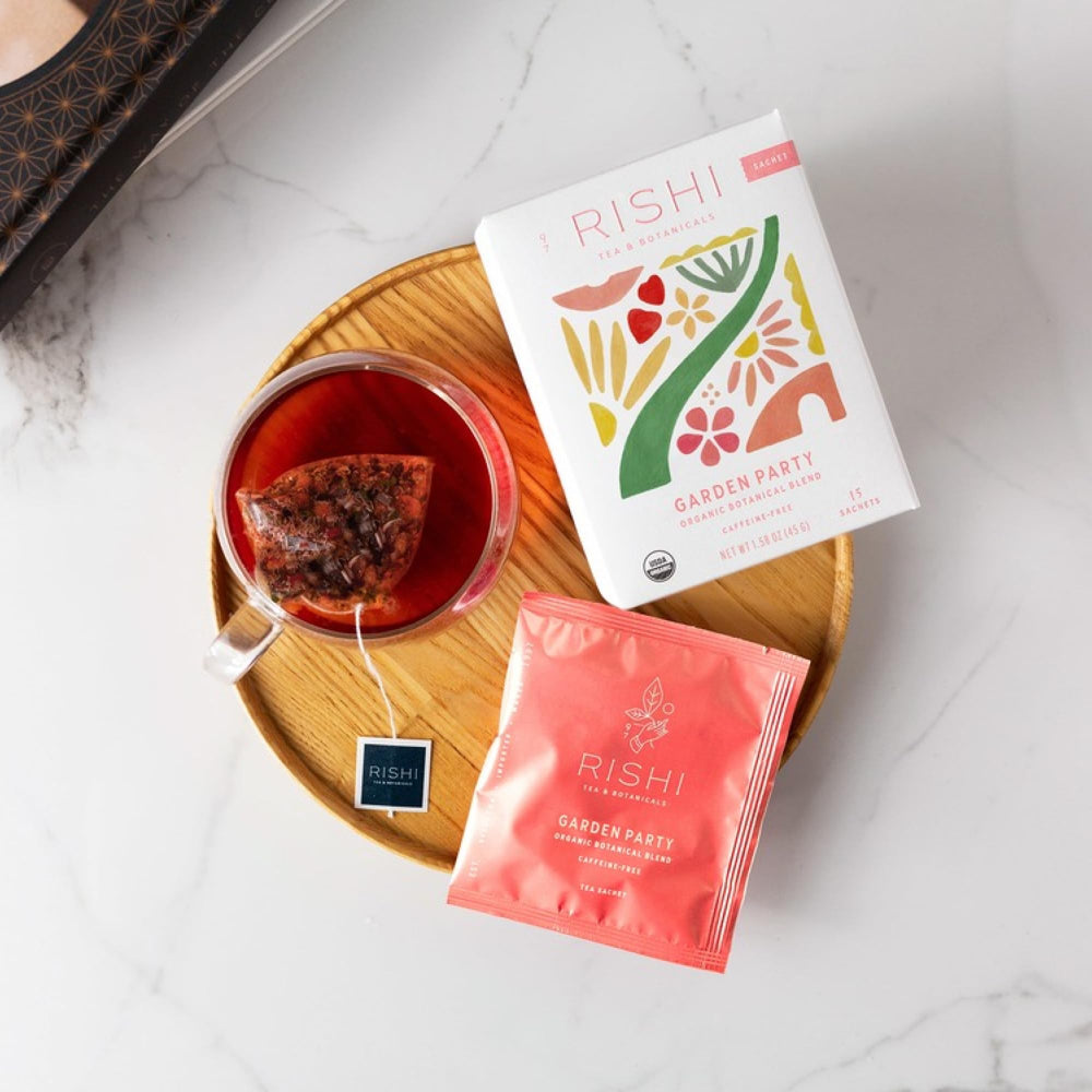 Rishi Tea Garden Party herbal infusion ready to enjoy in a glass cup.