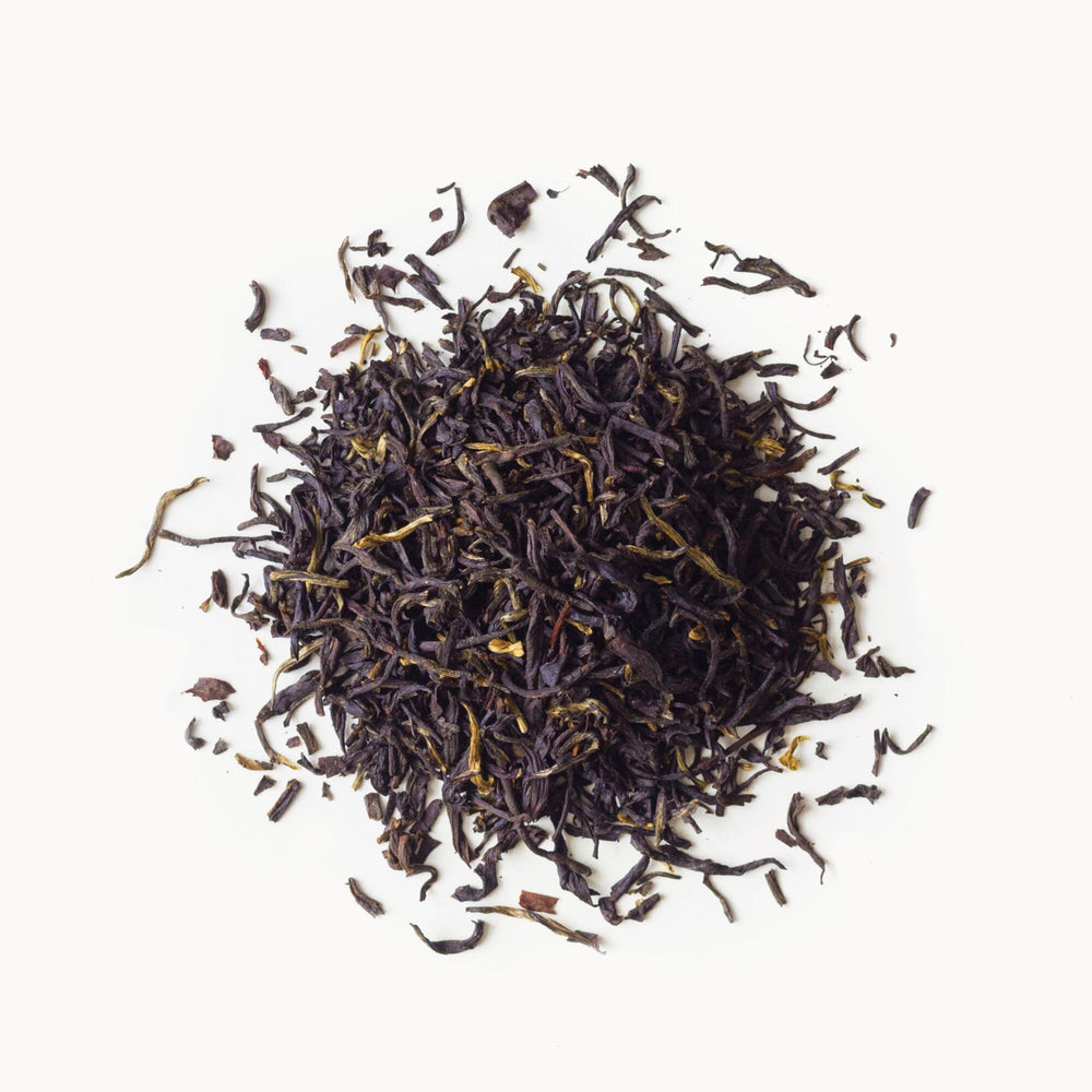 Rishi Tea tin packaging showcases organic, kosher, and non-GMO quality