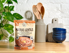 Microwave-ready Ritika’s Madras Lentils steaming from the pouch for fast prep.