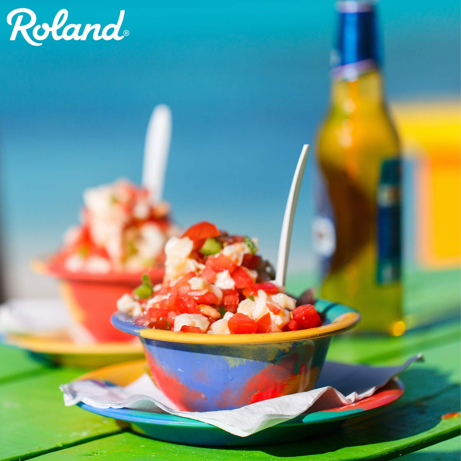 Roland Foods conch dish plated with fresh herbs and garnish.