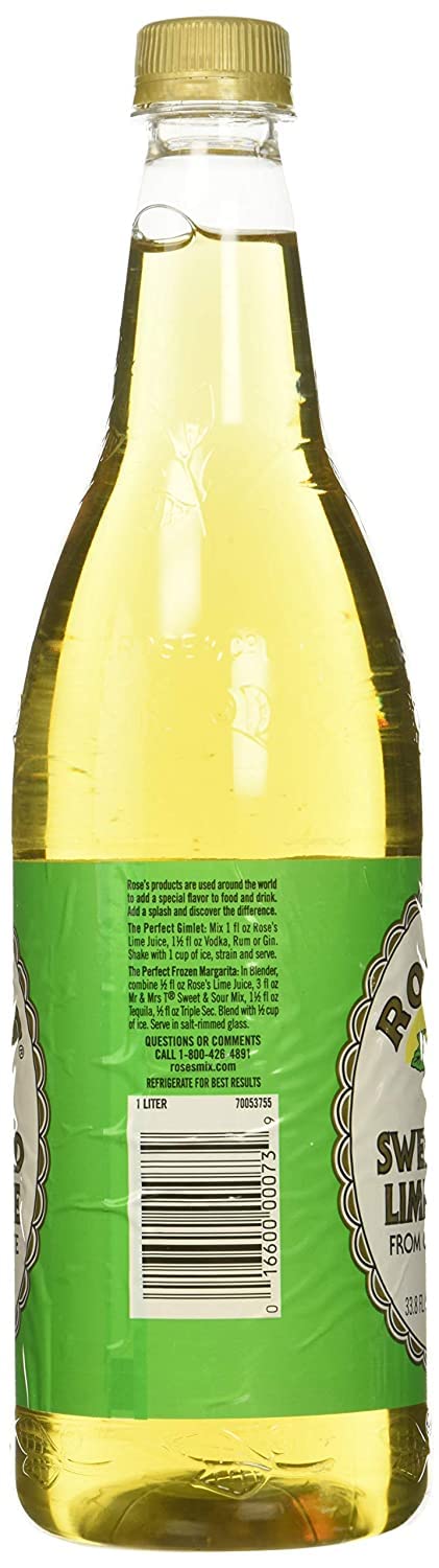 Rose's Lime Juice bottle beside fresh limes and a shaker