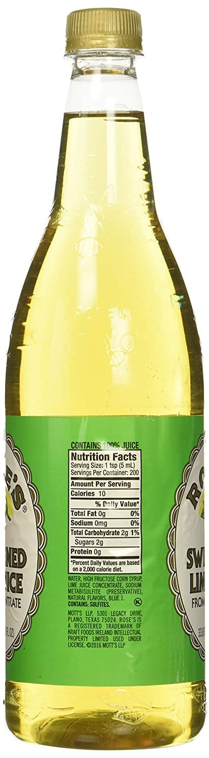 Rose's Lime Juice being poured over ice in a highball glass