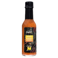 Rouxgaroux juice hot sauce pours smoothly for heat and depth