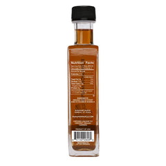 Amber glass Runamok syrup bottle highlighting premium organic Vermont maple.
