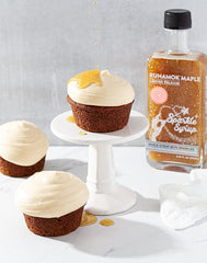 Pouring Runamok Sparkle Syrup over waffles and fruit for a sparkling glaze.