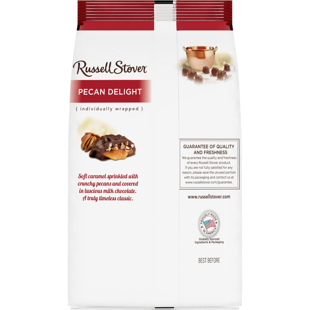 Gift-ready Russell Stover bag shown on a festive table setting.