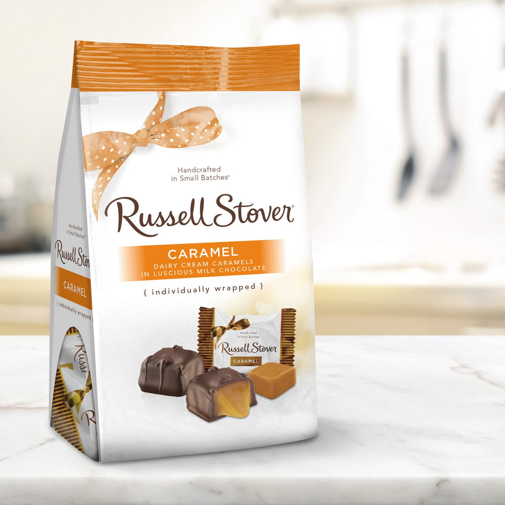 Sharing at a party, Russell Stover Caramels add a classic sweet touch.