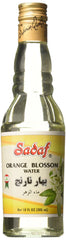 Pouring Sadaf orange blossom water into batter to flavor pastries.