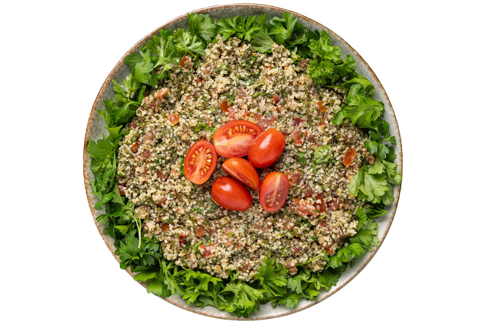 Family-style dinner setup with fresh veggies and Tabouli mix invites sharing