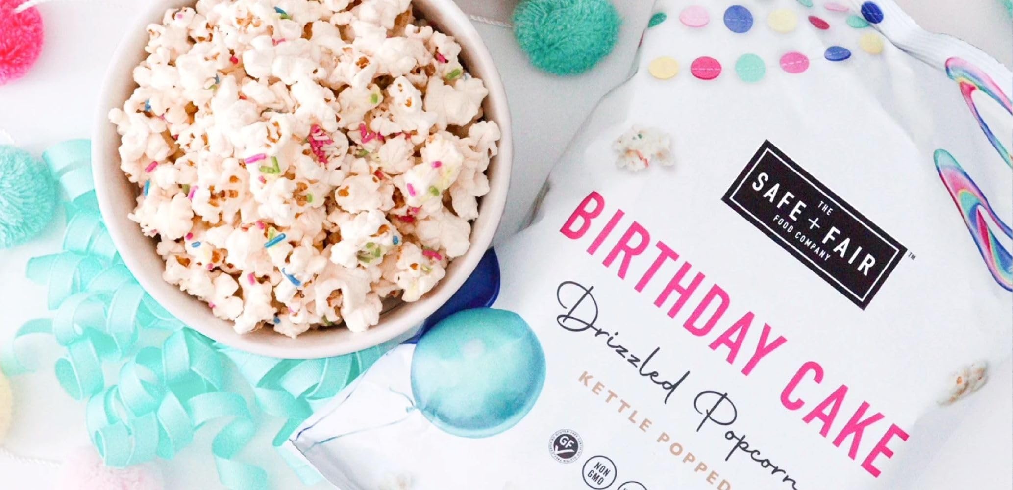 Open six-pack box of Safe + Fair Birthday Cake Drizzled Popcorn 5.5 oz bags