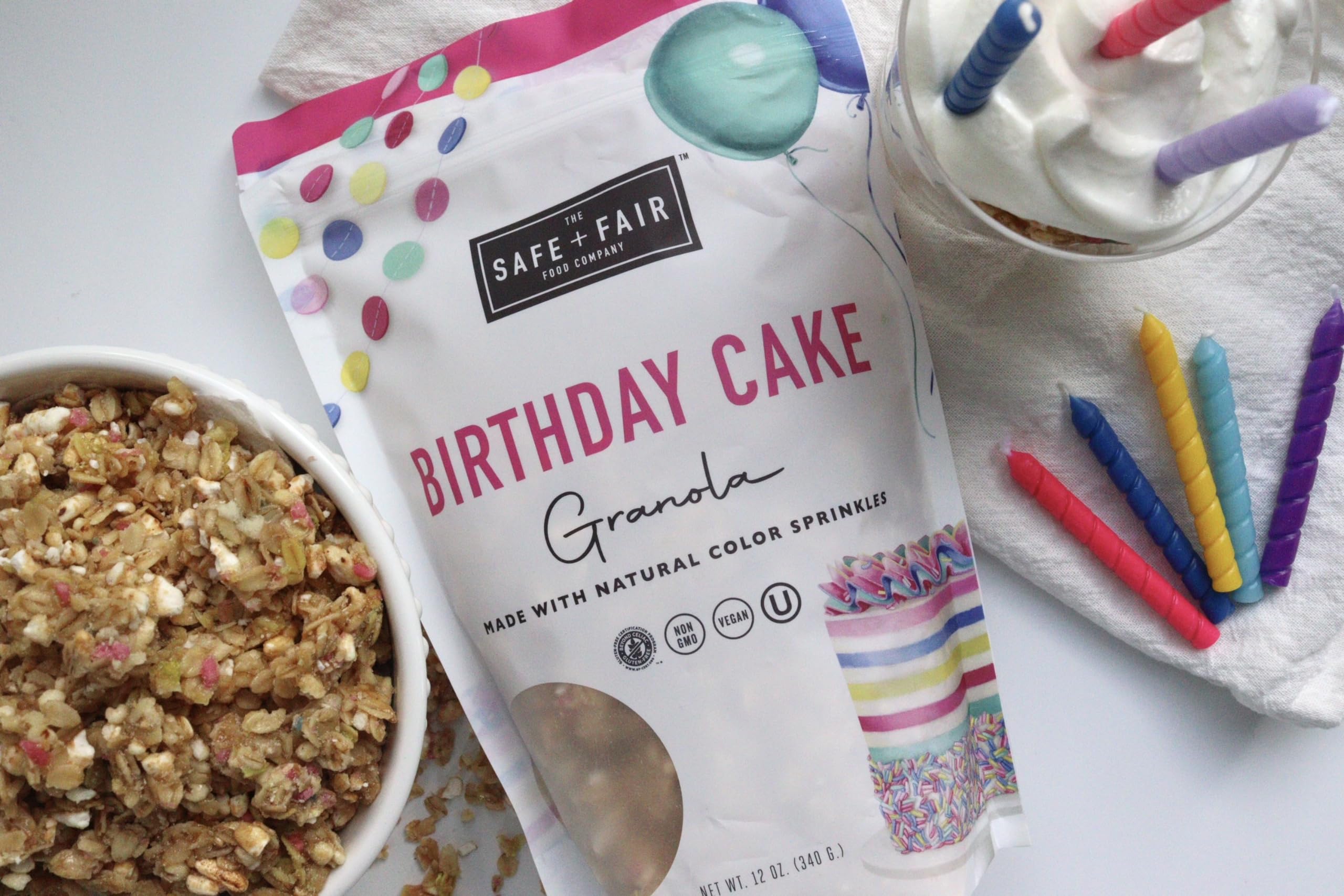 The Safe + Fair Birthday Cake Granola pouch opened, ready for a snack on the go.