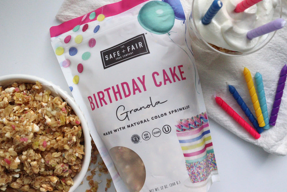 The Safe + Fair Birthday Cake Granola pouch opened, ready for a snack on the go.