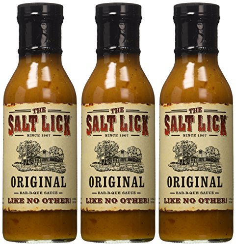 Grilling scene with Salt Lick BBQ Sauce ready to glaze meats.