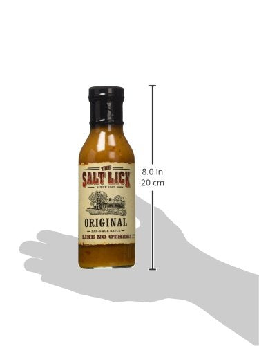 Salt Lick Original BBQ Sauce served over meats on a platter for bold flavor.