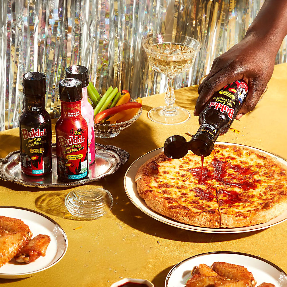 Tabletop scene showing Samyang 2X Buldak sauce ready to spice meals.