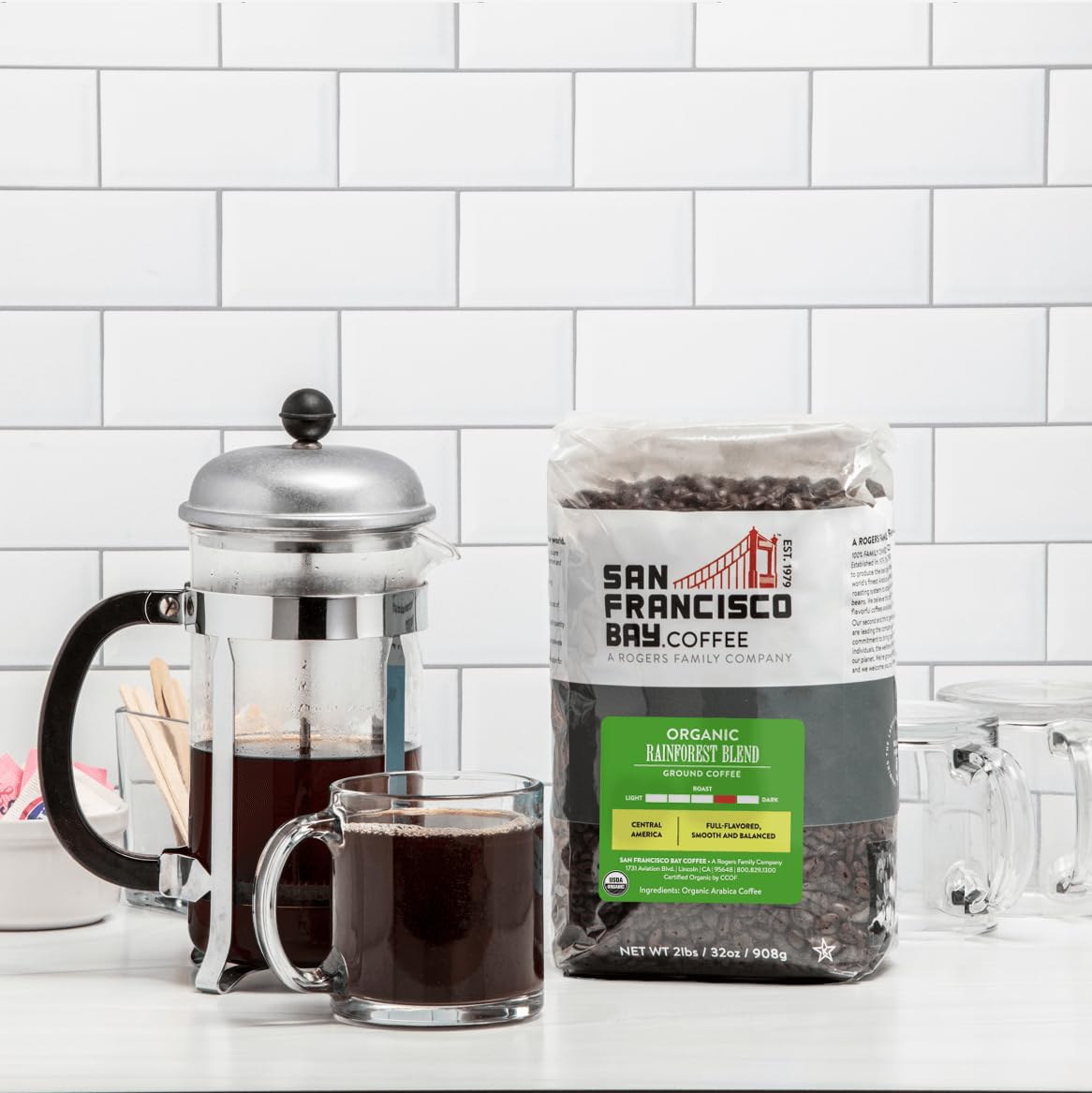 San Francisco Bay Rainforest Blend whole bean with scoop, ideal for home grinding.