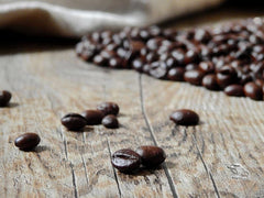 Pouring San Francisco Bay French Roast; rich, smoky aroma enhances bold morning cup.